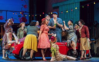 Center: Cadie J. Bryan (Giannetta), Jonah Hoskins (Nemorino), the Santa Fe Opera Chorus, photo by Curtis Brown for the Santa Fe Opera